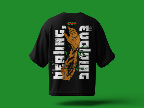 PjTees Black t-shirt with a graphic design on the back against a green background